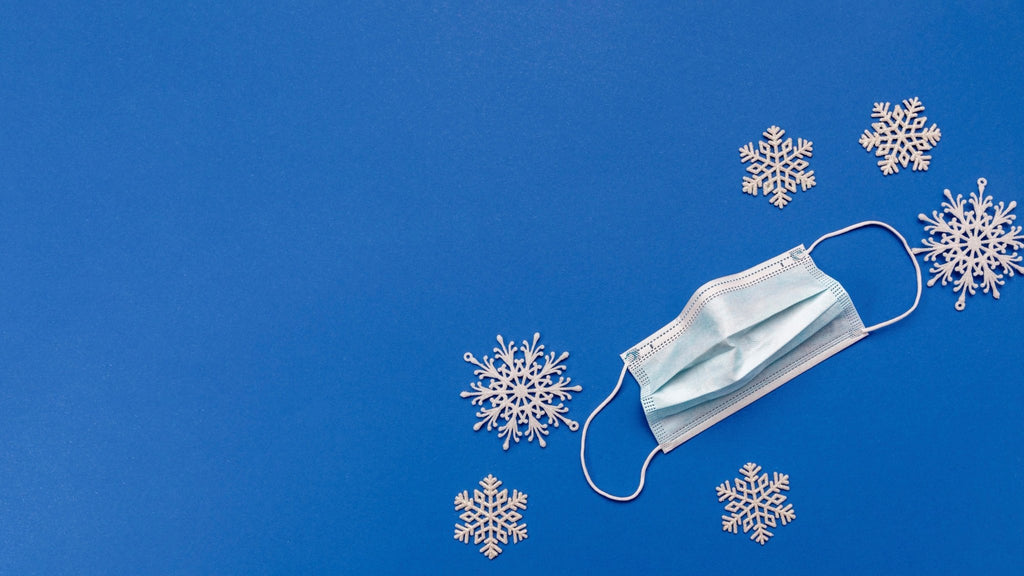 white mask on a blue background with snowflakes